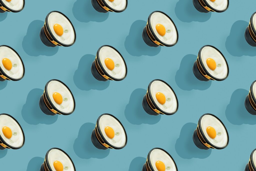 A repeating egg-shaped speaker on a blue background. Seamless pattern.