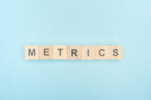 top view of metrics lettering made of wooden cubes on blue background